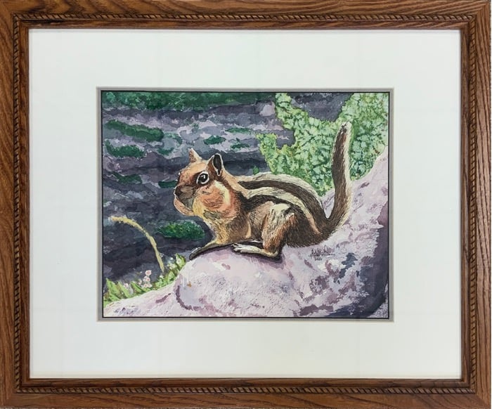 Framed ink painting of a chipmunk sitting on a rock with a green nature background.