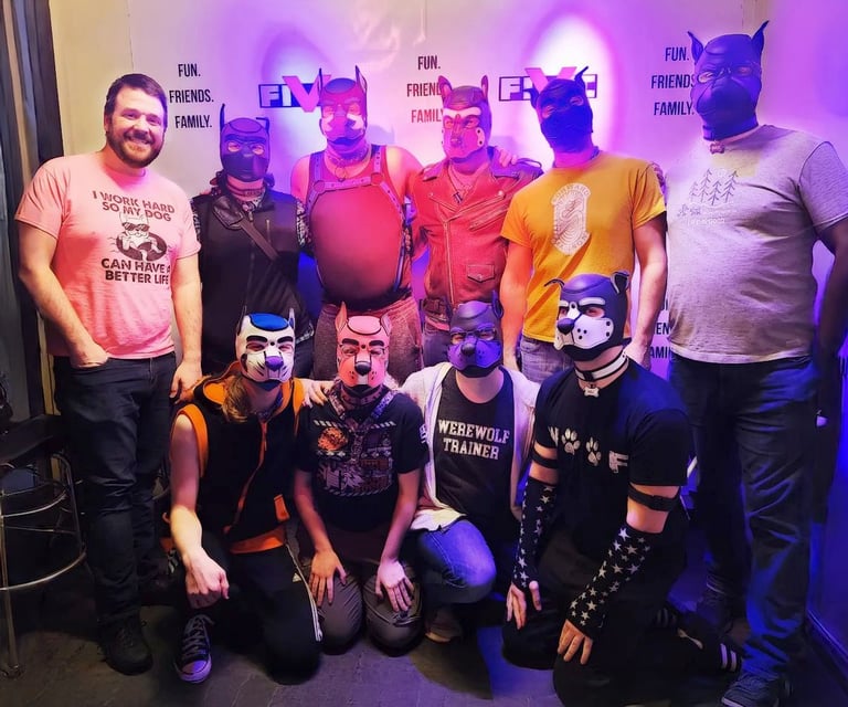 A group of men posing in pup masks.