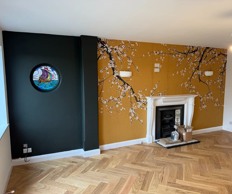 Wallpaper installation in a Brighton living room with fireplace