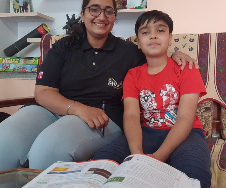 a tutor from gharpadh and a boy sitting on a couch