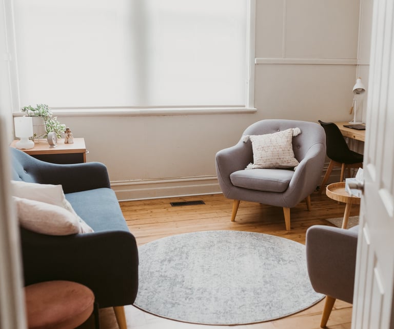 a consulting room in bright light with a chair and a couch