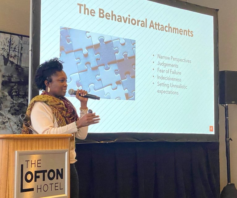 Beatrice Adenodi speaks to a group of professionals at The Lofton Hotel