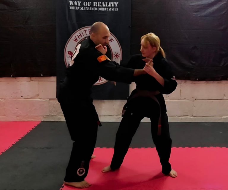 a man and woman doing a karate pose