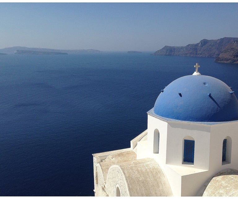 a blue dome shaped building with a blue dome shaped building in Santorini Cyclades