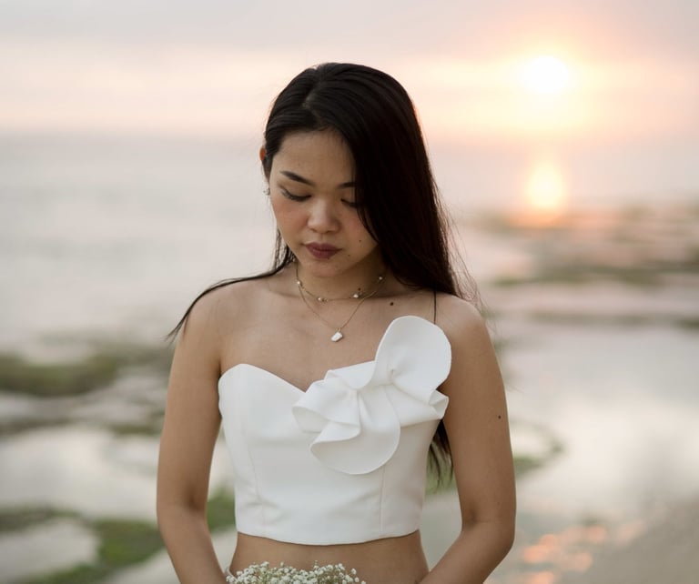 Bride portrait at sunset near ocean waves at Melasti Beach Bali