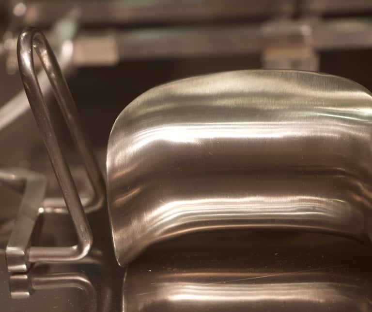 Closeup photo of steel shiny surgical tools on a glassy shelve.
