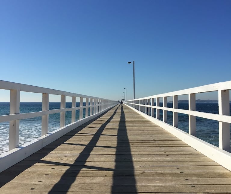 A single point persective looking down a pier