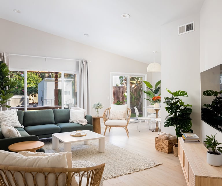 a living room with a green couch and a television