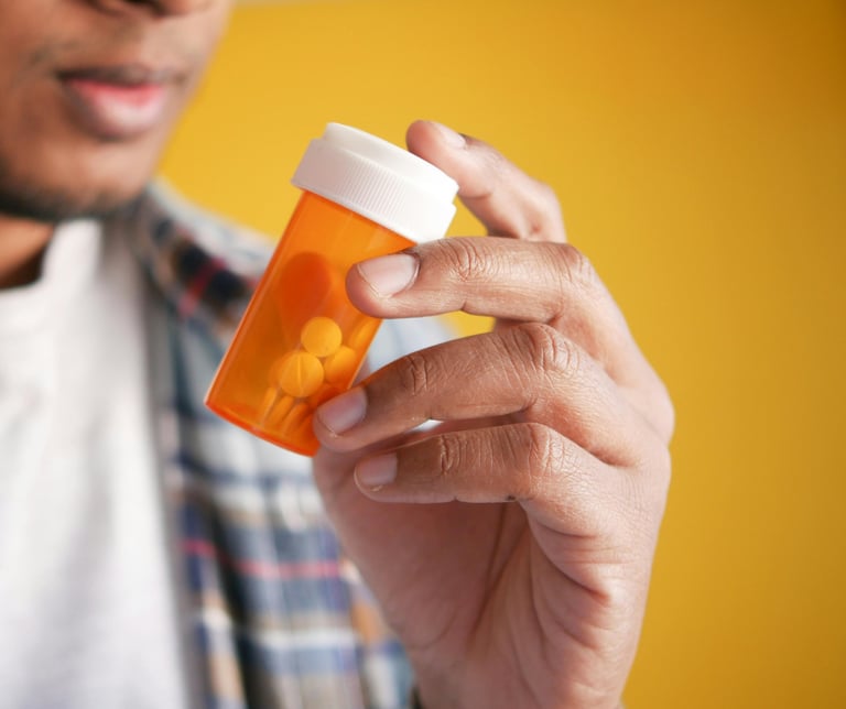 Male hold a prescription bottle