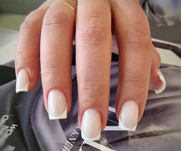 a person's hand with a computer mouse on a mouse pad