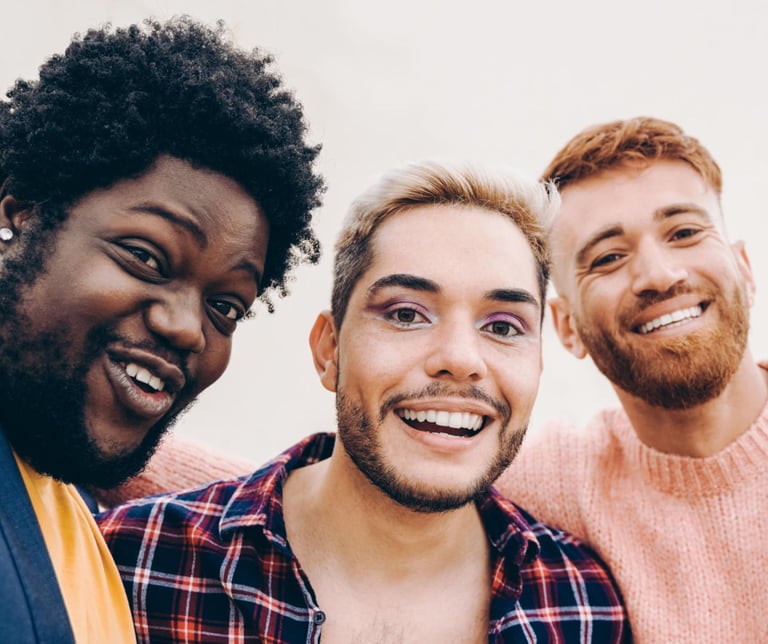 three men standing next to each other with a smile on their faces