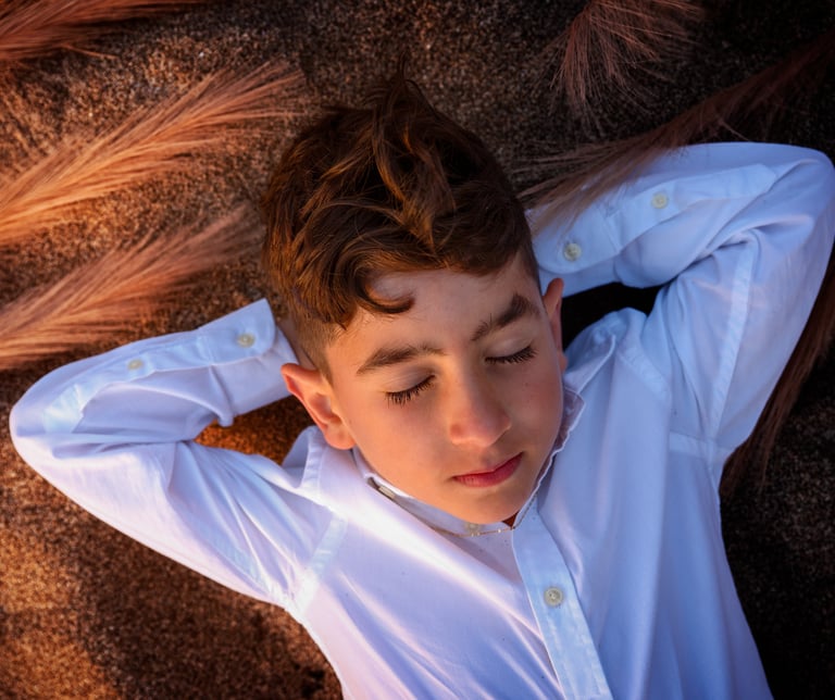 a young boy wearing a white shirt and tie