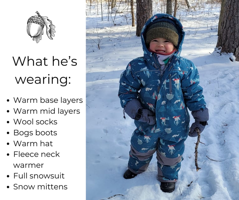 a young child wearing a blue snowsuit and a hat