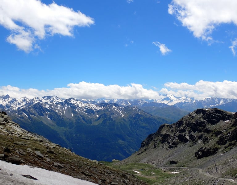 a person on a mountain with a sky background