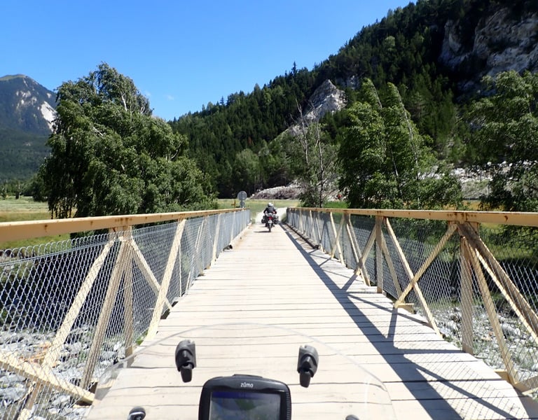 a motorcycle on an old bridge over a river