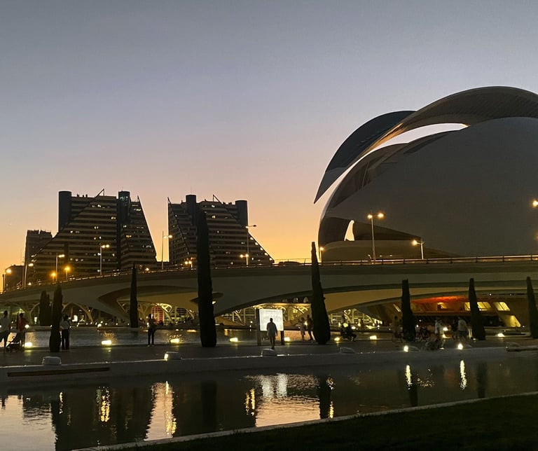 Vista nocturna de Valencia con el Palau de les Arts Reina Sofía iluminado y reflejado en el agua