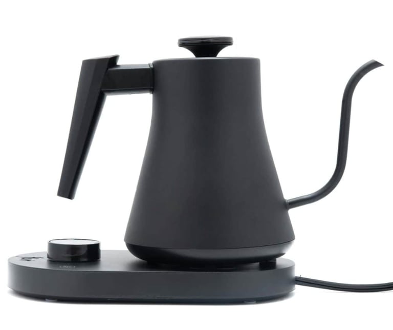 Matte black electric gooseneck kettle for pour over coffee brewing on a minimalist base.