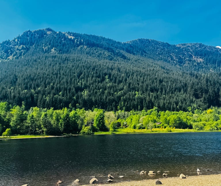 a mountain scene with a lake and mountains in the background