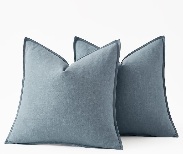 Set of three dusty blue linen decorative throw pillows with flange edges for home decor.