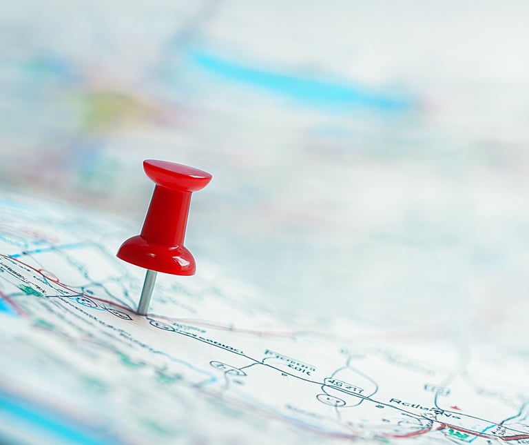 A thumbtack stuck into a map