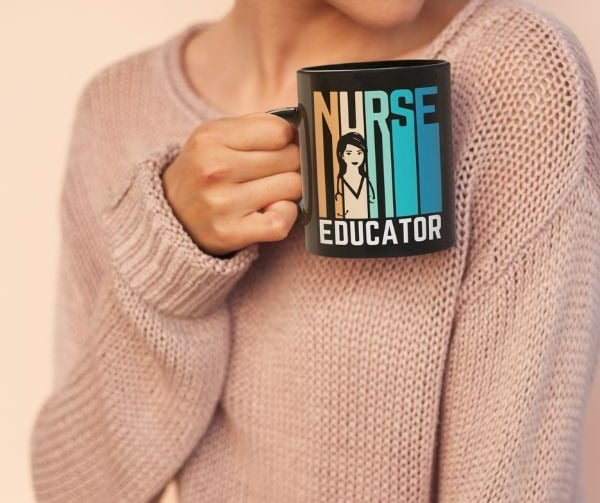 Woman holding a Nurse Educator design mug