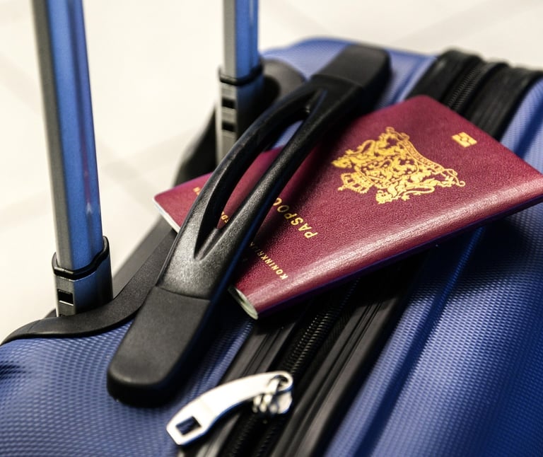A passport resting on top of a suitcase, suggesting travel or preparation for a trip