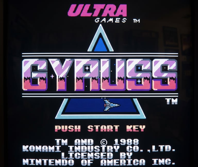 Gyruss title screen for NES by Ultra Games, featuring a 1988 Konami license on a CRT monitor.