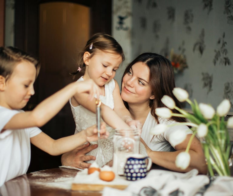 a mother and two children baking or cooking together