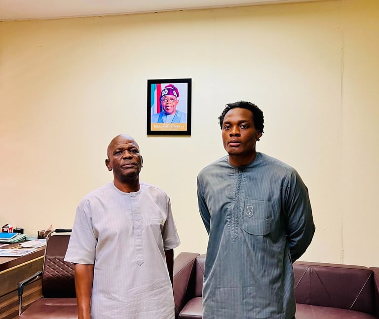 two men standing in a room with a couch and a couch