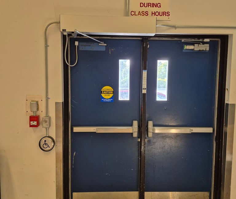 A school door has a door operator installed