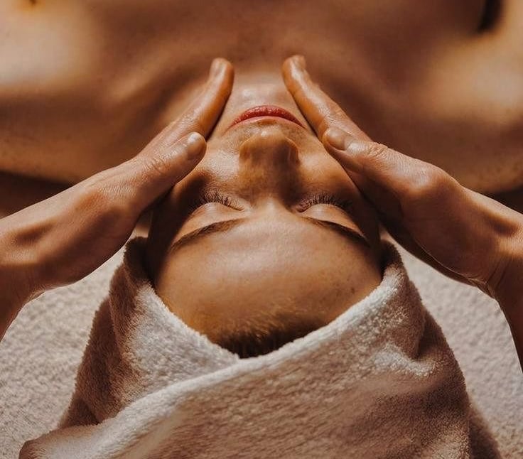 a woman getting a facial massage at a spa