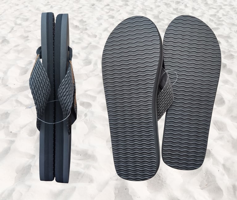 Burnsea black Onyx EVA men's thongs on a sandy beach