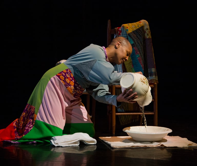 Anjali on stage during a performance with the quilts and water