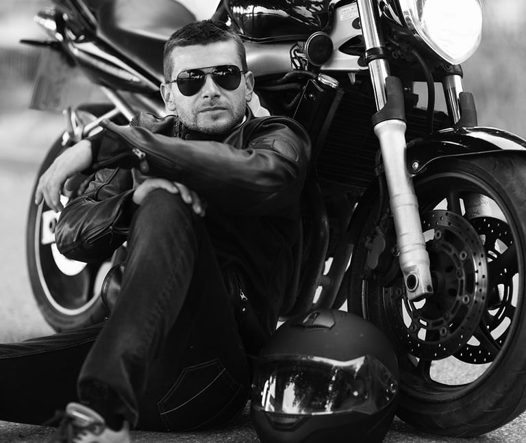 Audrius Turskas - a cool man sitting on the ground next to a motorcycle