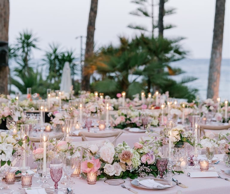 Romantic destination wedding dinner setup with floral centerpieces and candles at Villa El Rincon