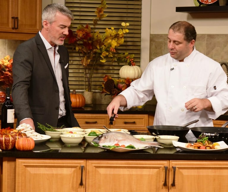 two men in suits and ties standing in a kitchen