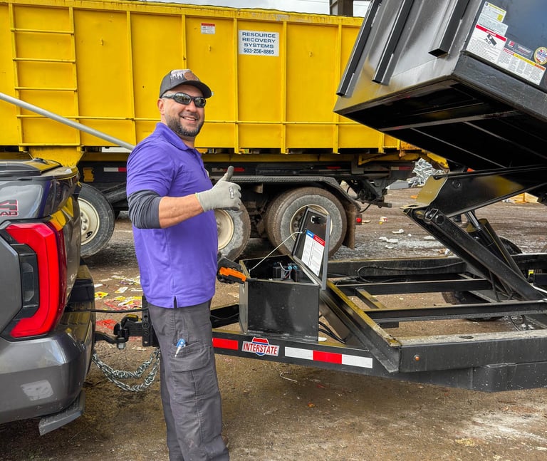 A smiling worker giving a thumbs up after a junk removal job in Portland