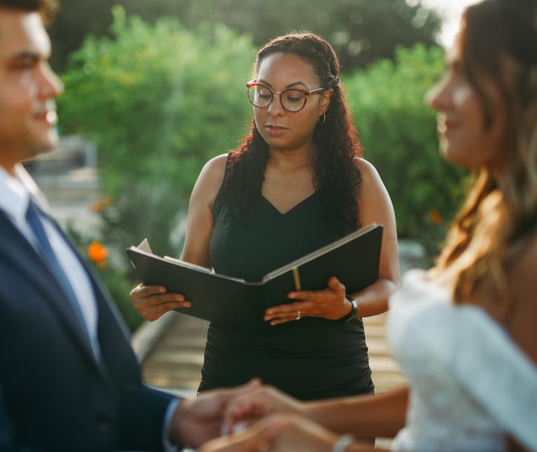 Professiona Florida wedding officiant reading vows for a couple during an outdoor marriage ceremony.