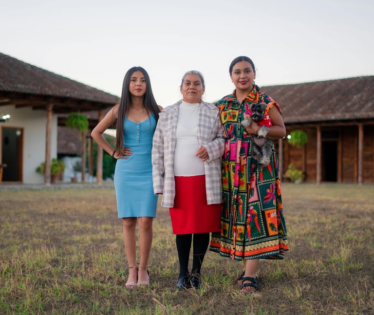 3 women: young, middle aged, elder standing confidently next to each other.