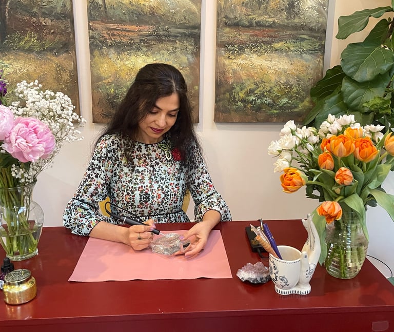Radhika, artist behind Bella Calligraphy engraving a perfume bottle