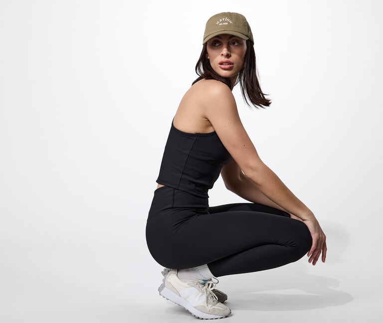Fashion e-commerce photography - a woman in a black top and white sneakers
