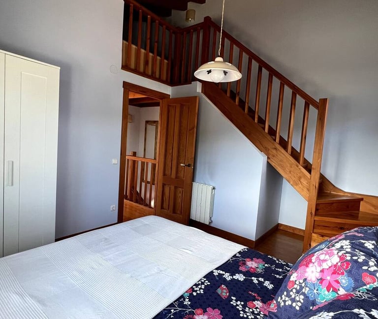 a bed with a bed and stairs leading to a staircase