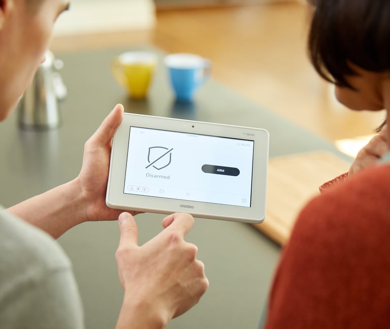 a man and woman holding a tablet computer