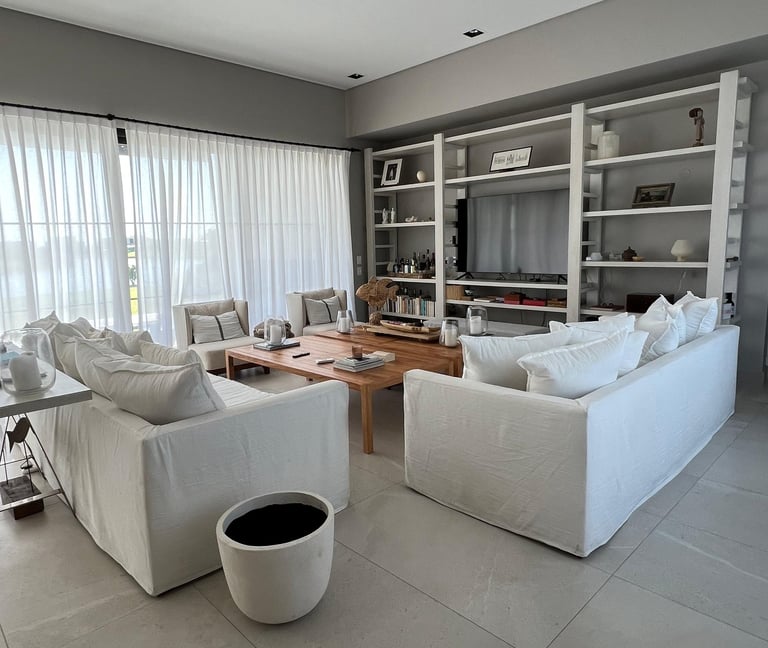 a living room with a large white couch and a coffee table