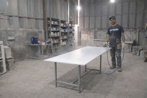 a man in a black shirt and a white table