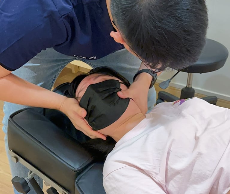 Chiropractor performing neck adjustment for pain relief at Sinisana Chiropractic