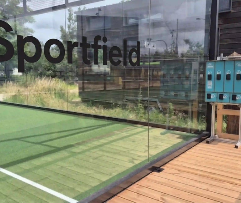 Outdoor Sportfield padel court with glass walls and equipment lockers on a wooden deck.