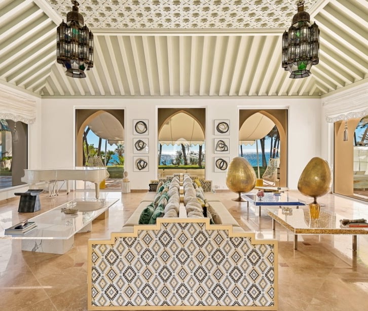 Living room at Villa El Rincon in Marbella featuring sea views, elegant décor, and floor-to-ceiling windows.