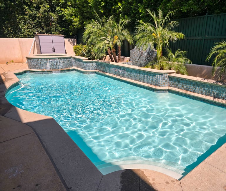 Modern pool with crystal-clear water and sleek tile design, ideal for showcasing luxury pool maintenance by Piscus Pools.