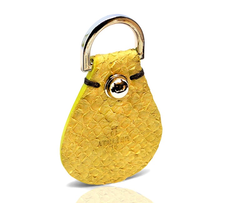Handmade yellow exotic leather key fob with silver hardware .